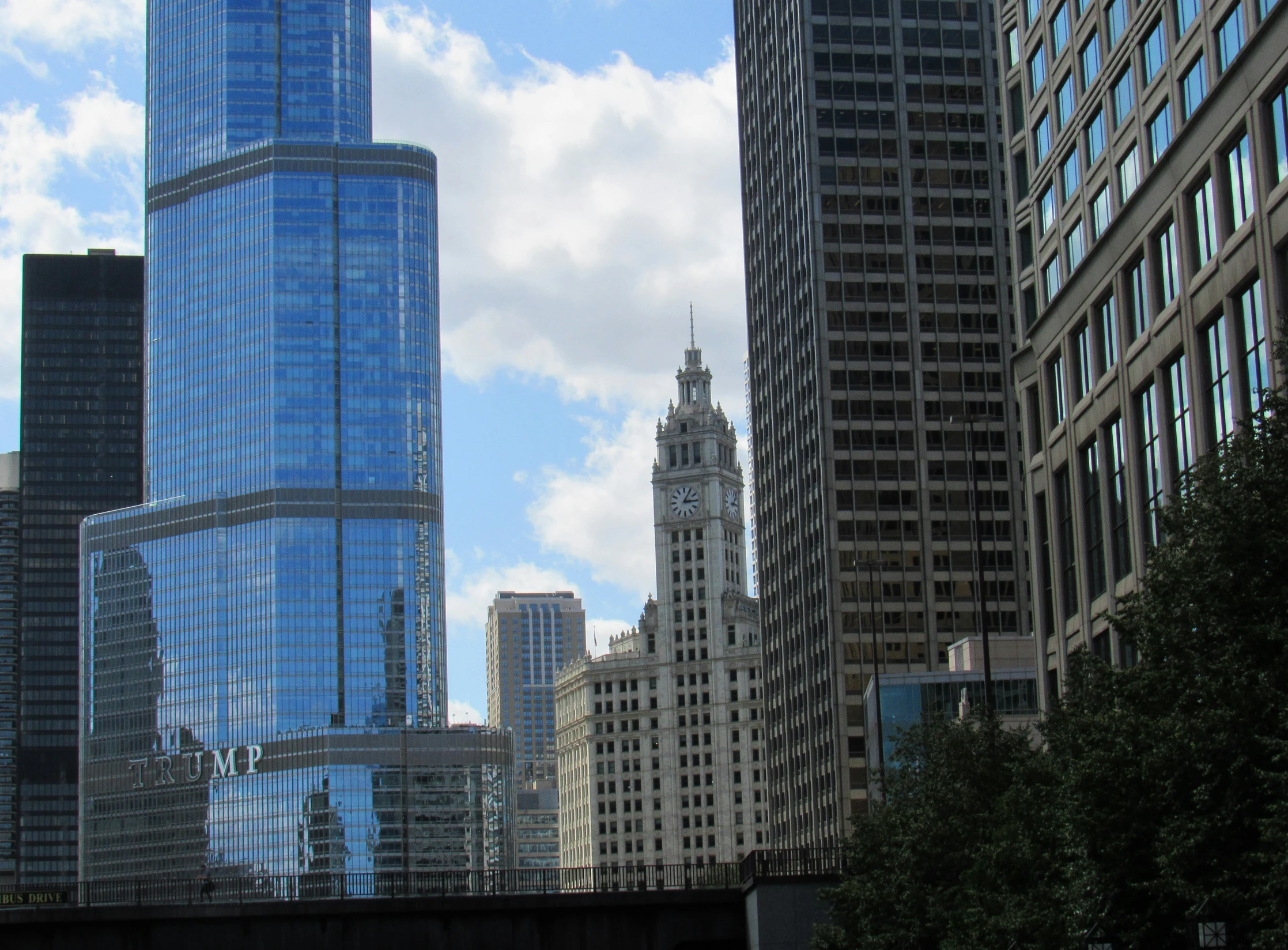 a train is on the tracks beside tall buildings