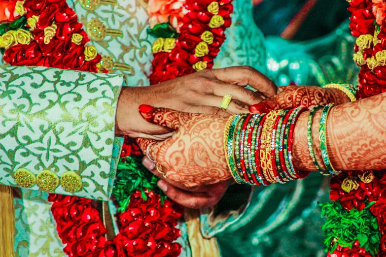 the couple are married during their ceremony, wearing wedding jewelry