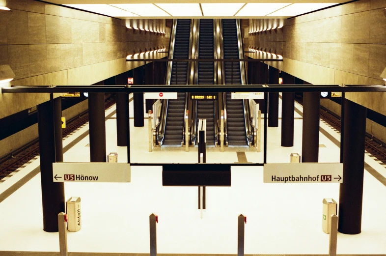 an empty building with escalators and signs