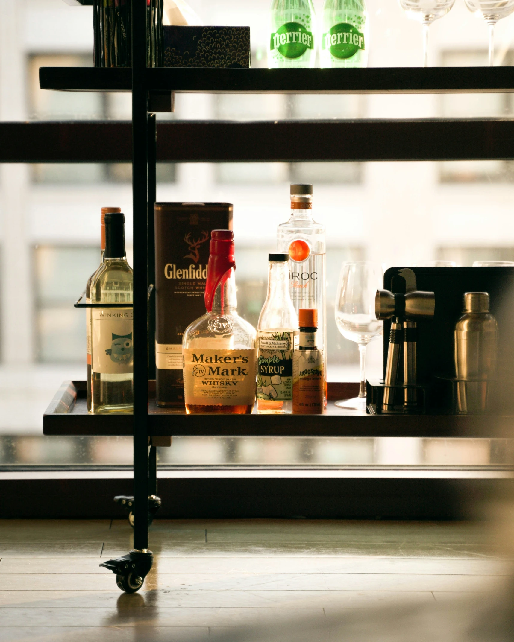 there are several bottles of liquor in this cupboard