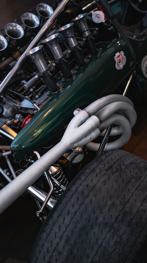 the bottom of an antique green motorcycle with wheels