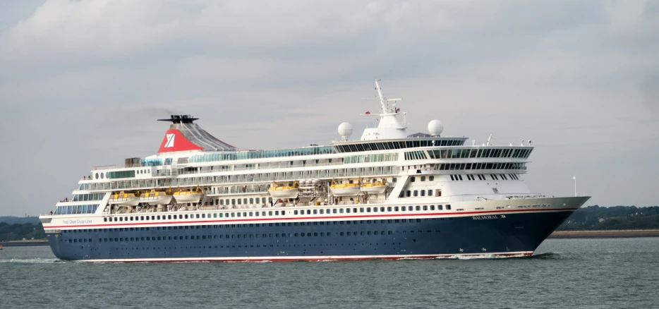 a cruise ship in the water at a cloudy day