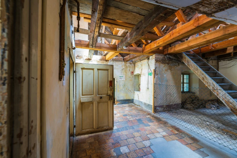 a doorway leads to a staircase inside an old stone house