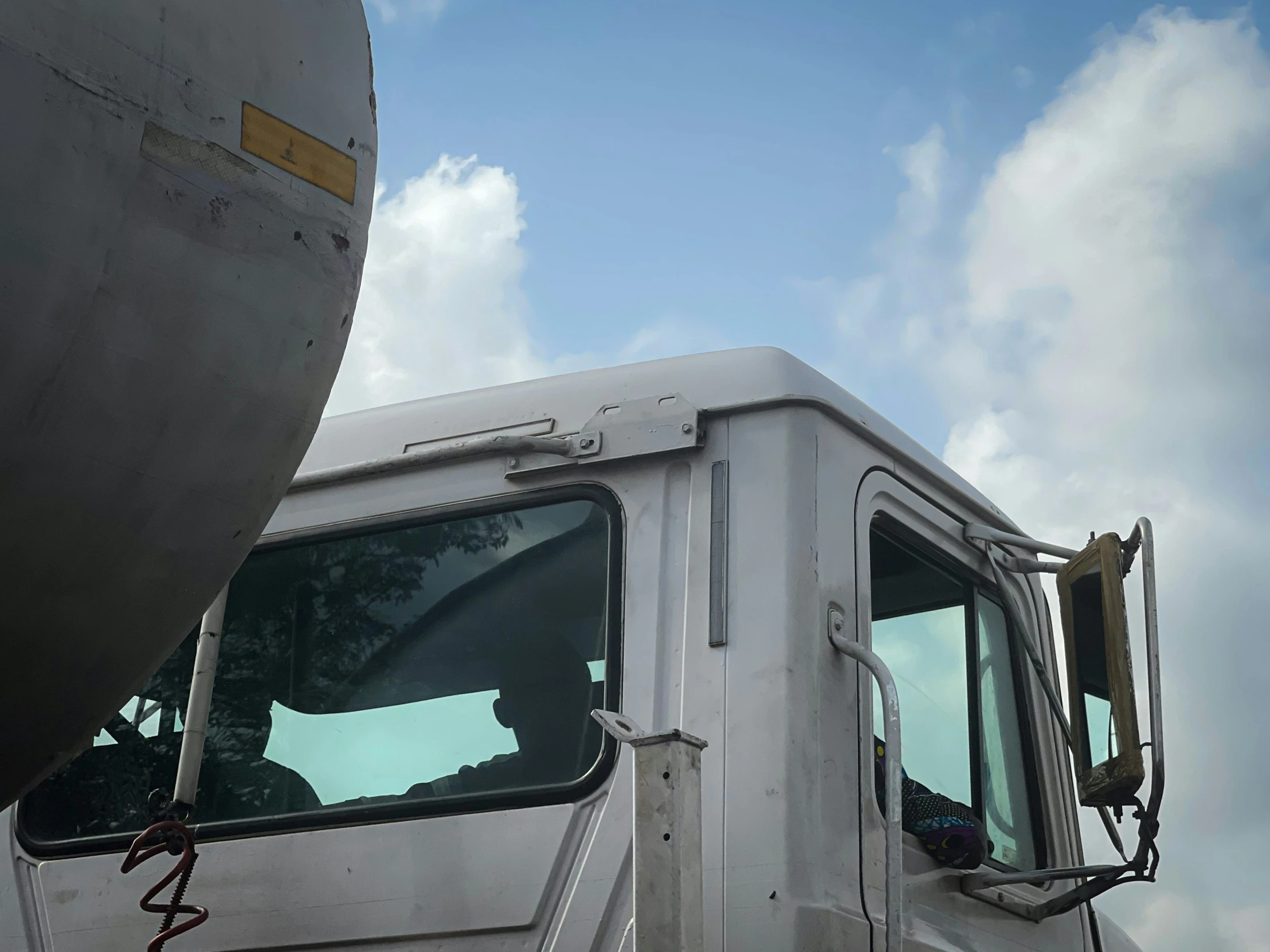 a white truck with several large mirrors on it's side