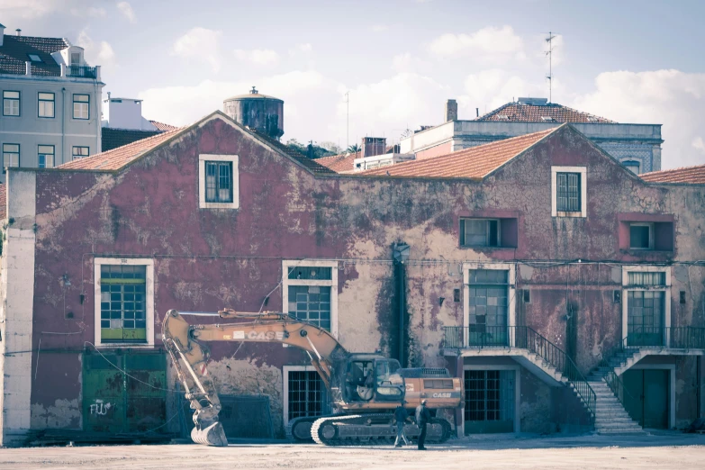 an old building with a broken down bike sitting in the front