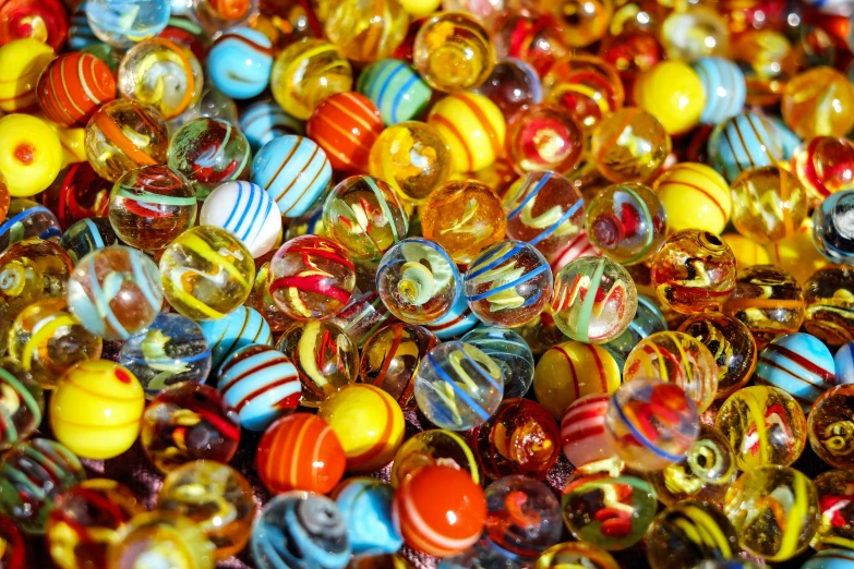 a close up s of many glass marbles