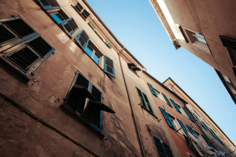 a picture of a building with many windows and blinds