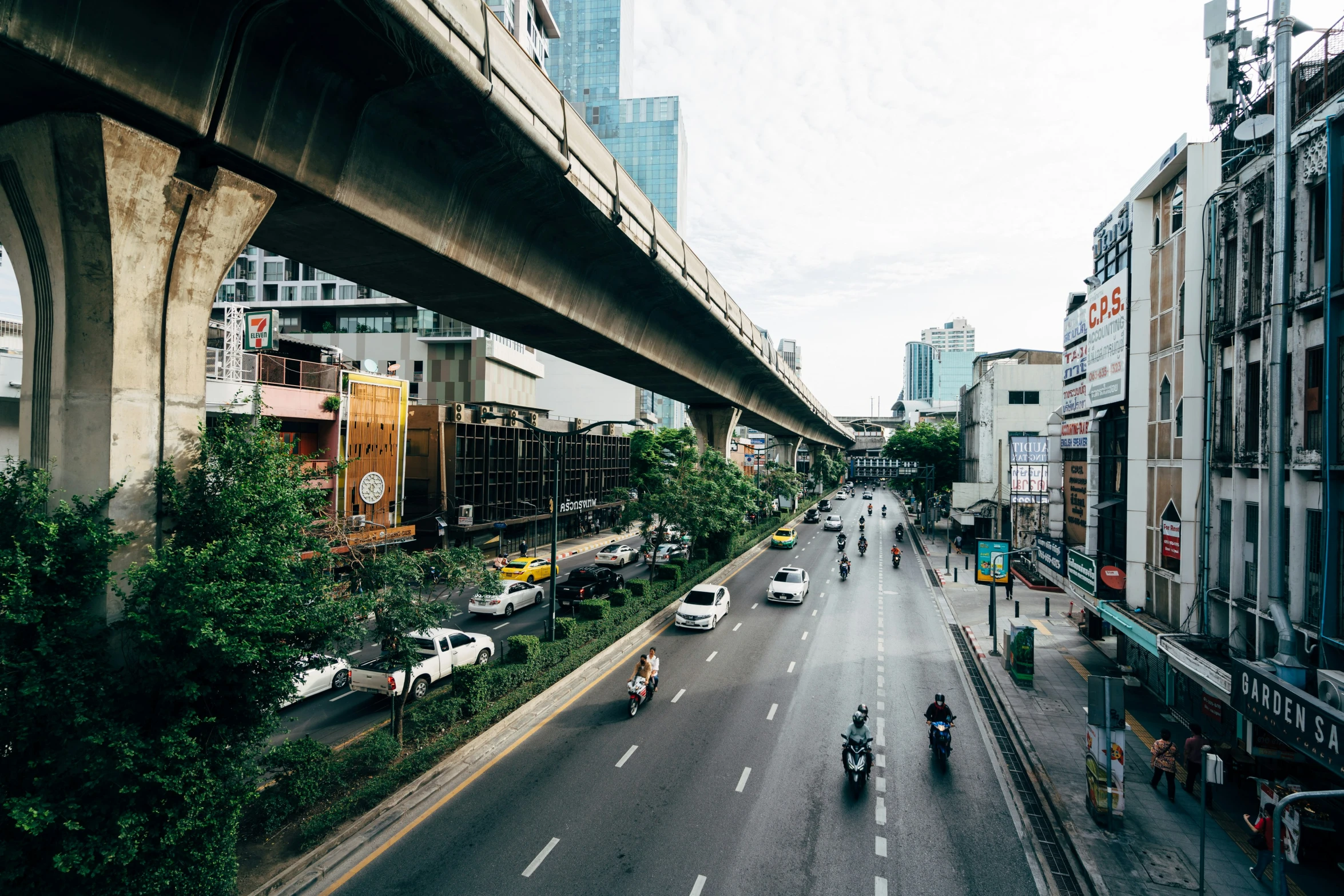 people driving on a street below a bridge