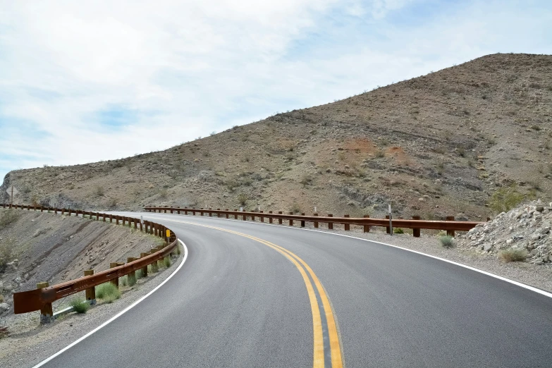 a road is empty, with a gate on the side