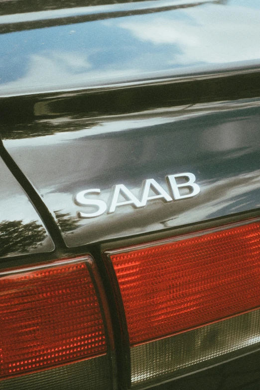 a car with the saab logo is seen parked