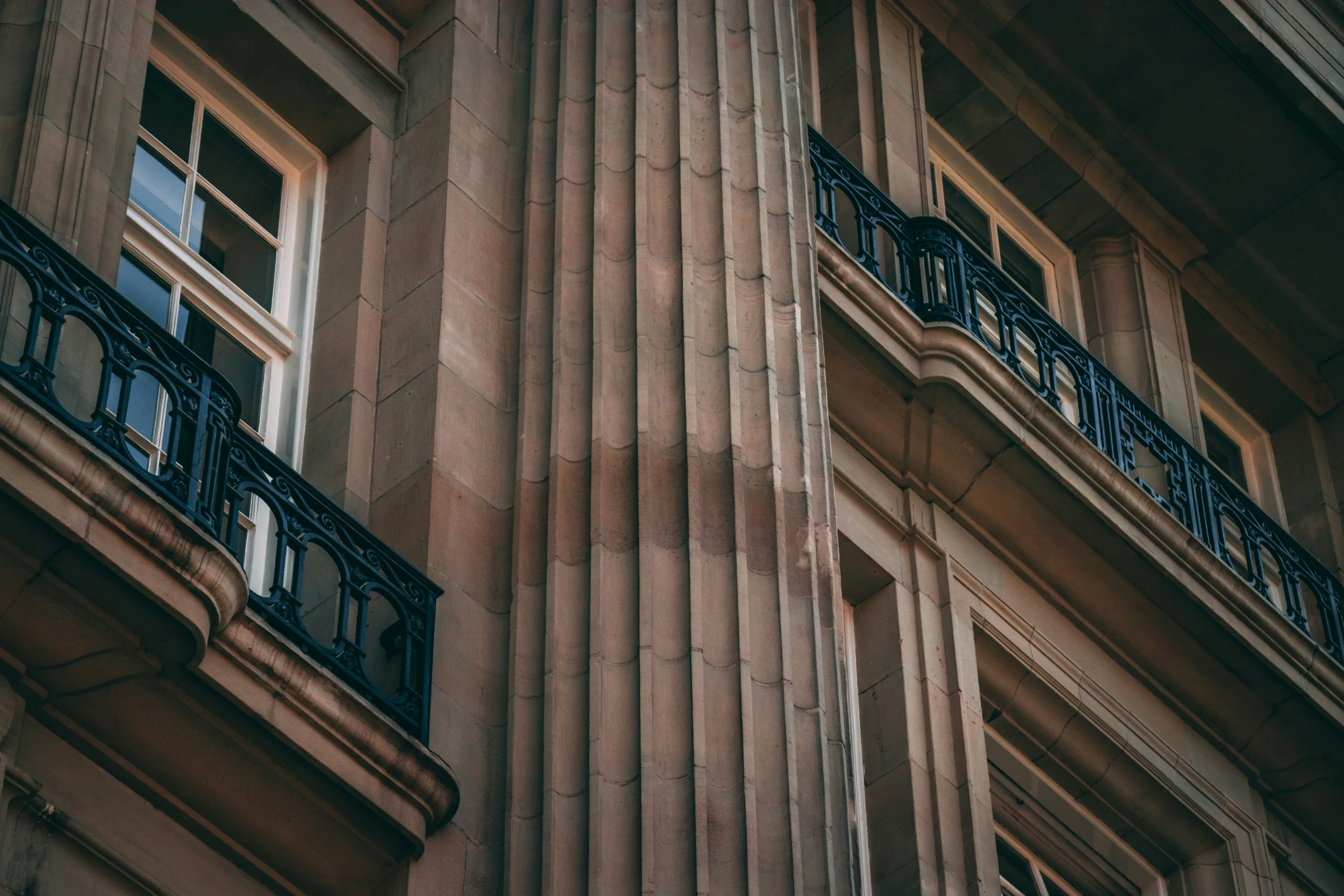 an old building has wrought iron balconies and windows