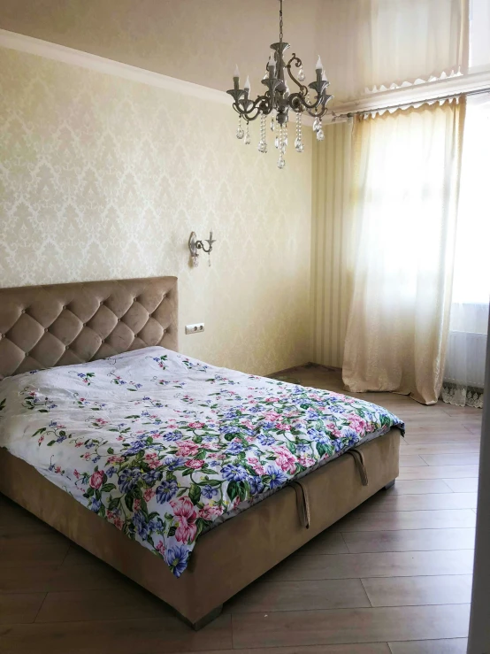 a bedroom with large bed in it and a chandelier