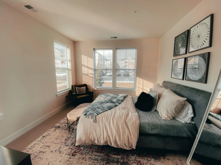 bedroom with a bed, desk, television and large windows