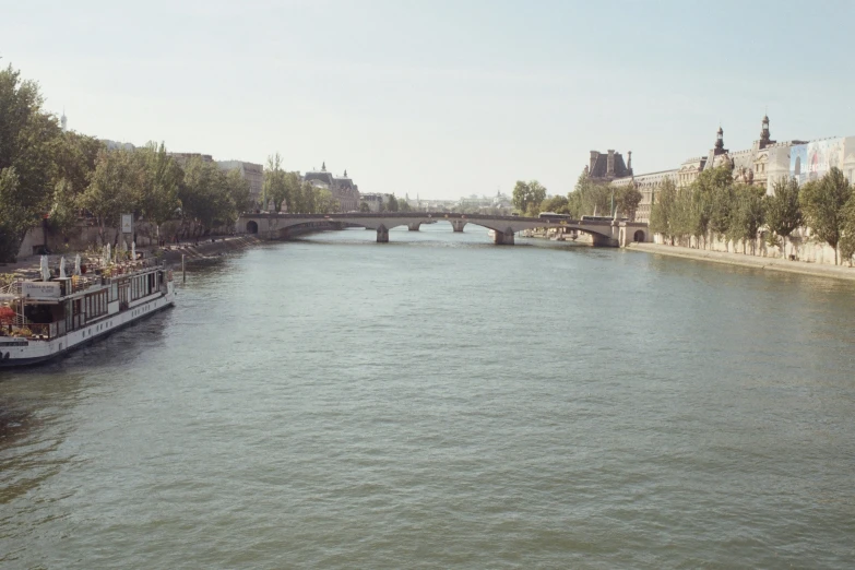 a river with a boat going down it near some buildings