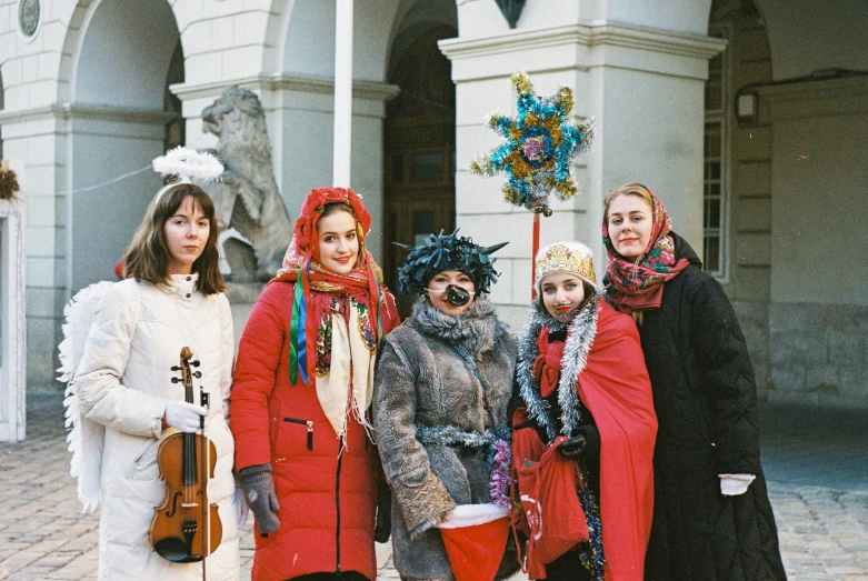 four woman wearing costumes and makeup pose for a picture