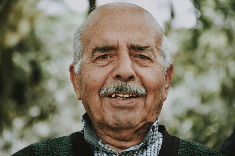 a smiling older gentleman poses for the camera