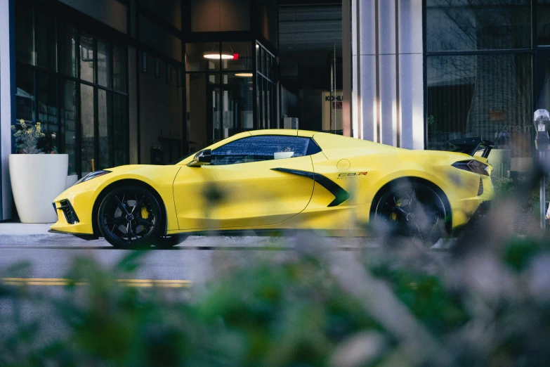 a very bright yellow car parked on a street