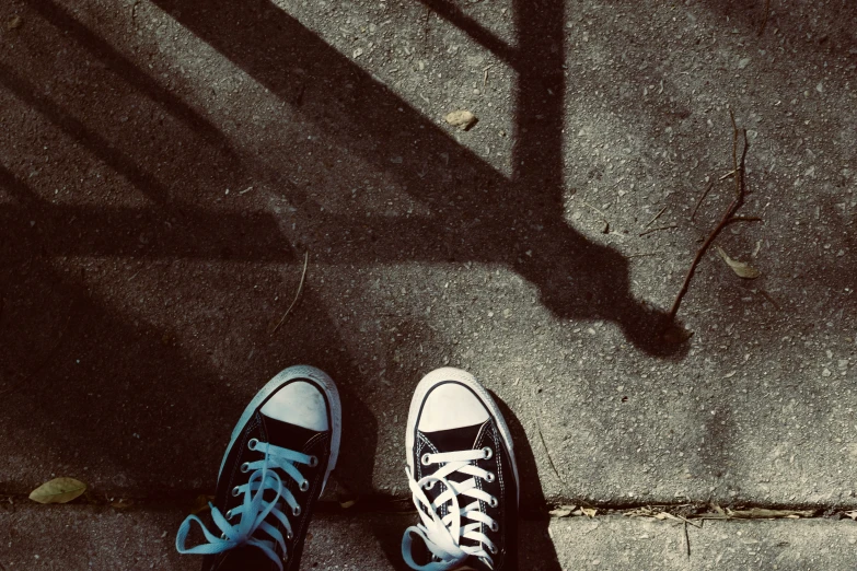 two people are on the sidewalk near one another