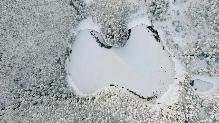 aerial view of snow covered ground with footprints