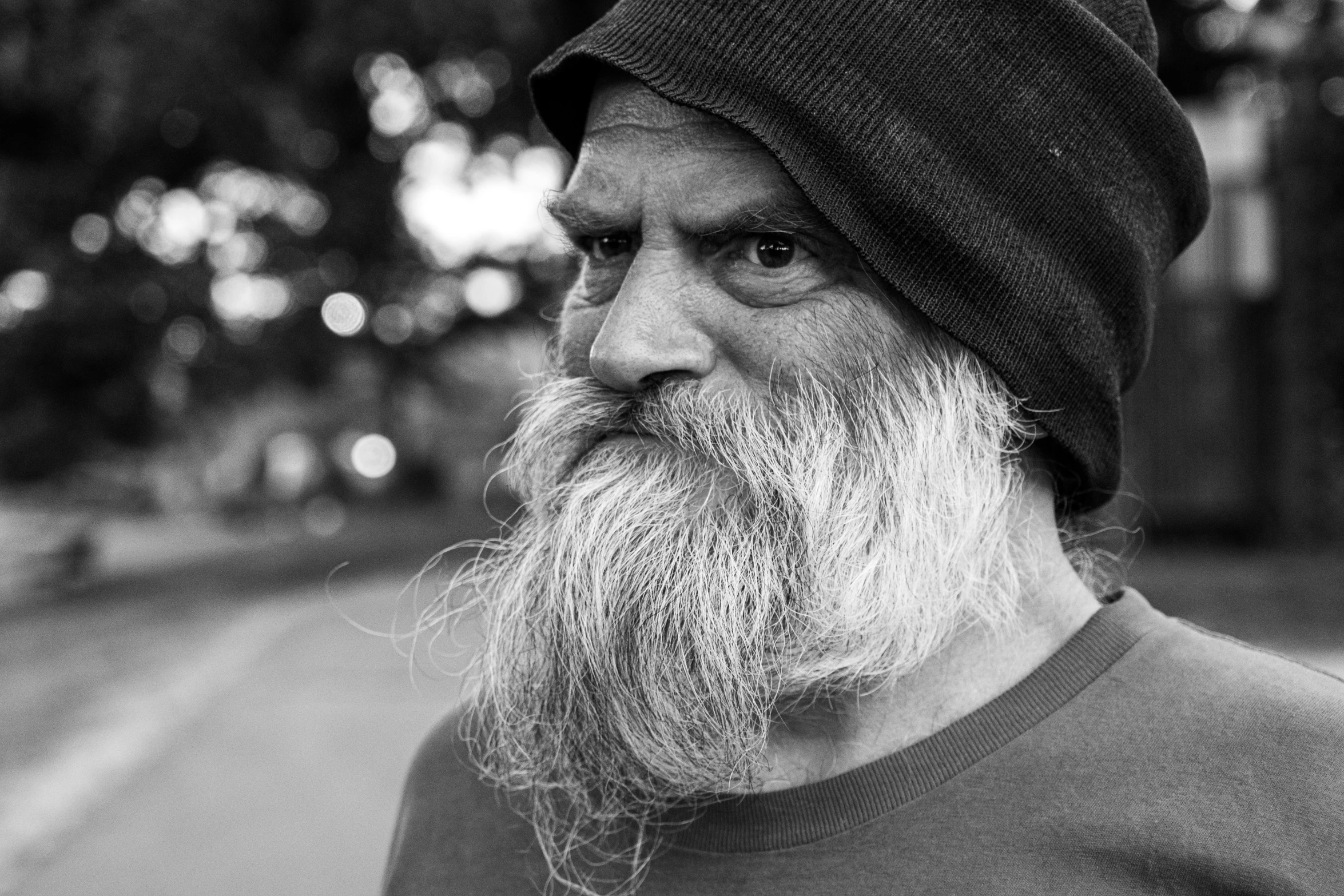 black and white image of man with large beard wearing a beanie