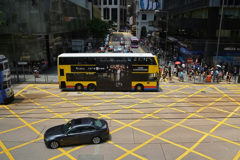 a bus driving on a busy street surrounded by buildings