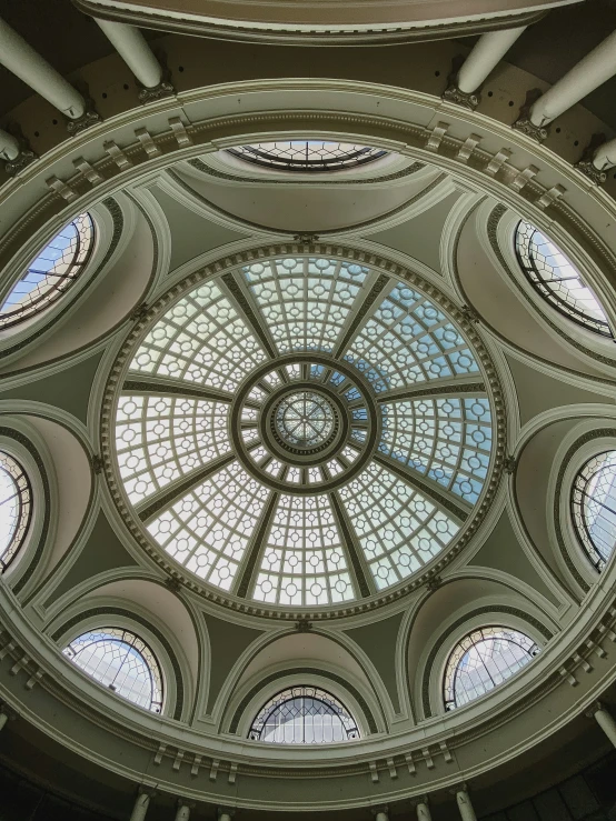 a circular ceiling with glass windows above it