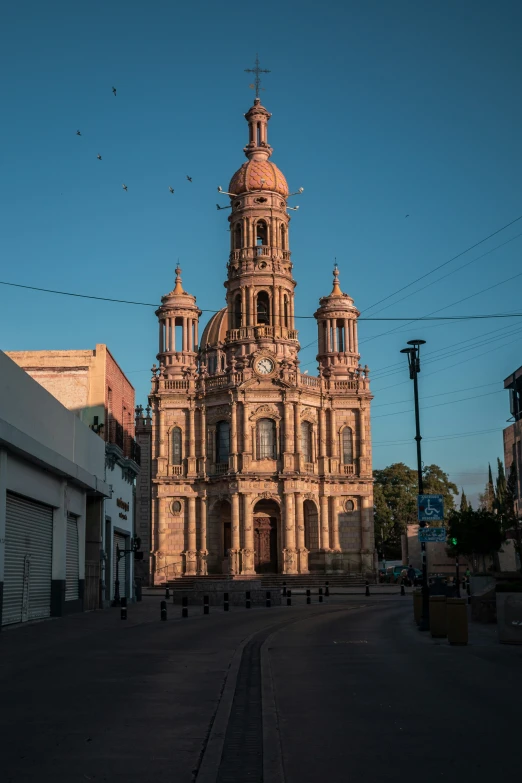 a tall church tower standing in the middle of a street