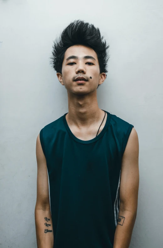 young asian man wearing an all black tank top