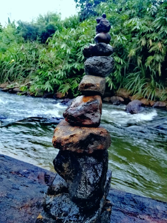 a pile of rocks sitting next to a river