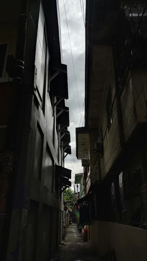 a dark alleyway leading to other buildings