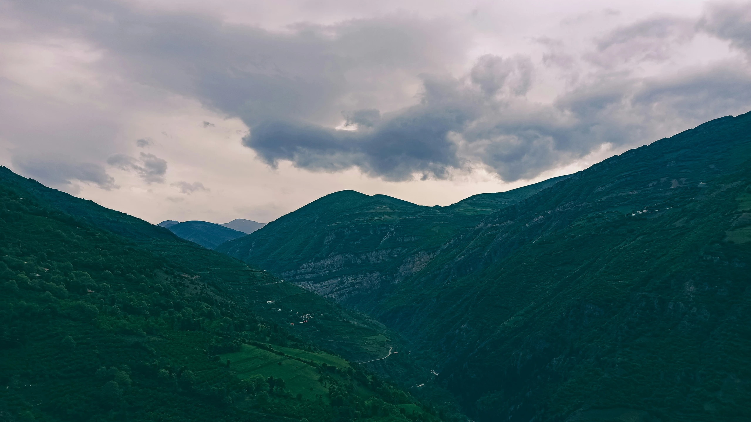 a plane flies high above some mountains