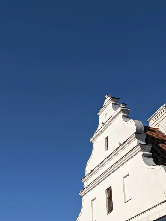 a tall white tower with windows on the top of it