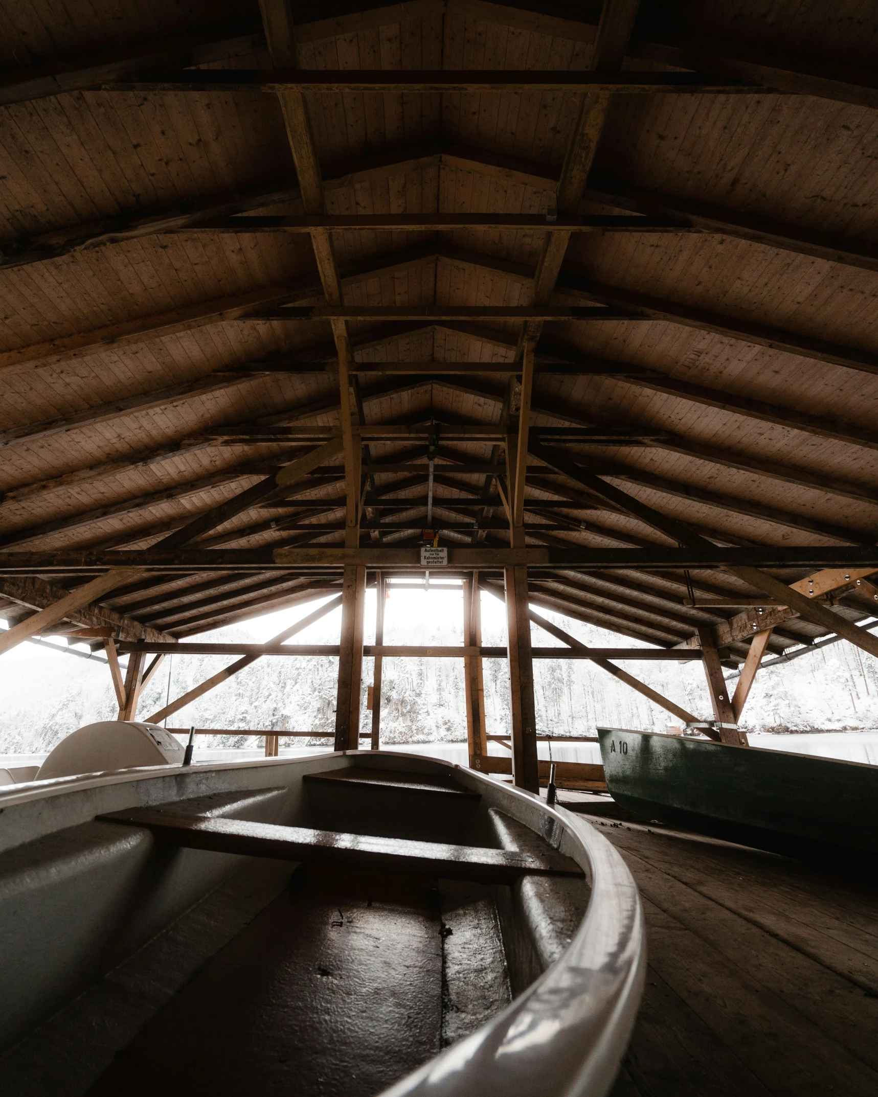 a couple of small boats on top of a wooden floor