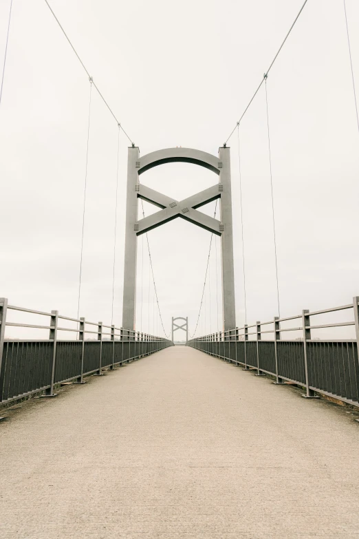 an empty road leading to an ornate bridge