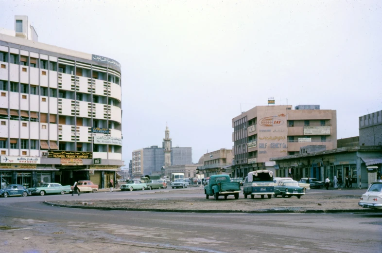 a few cars are driving down a city street