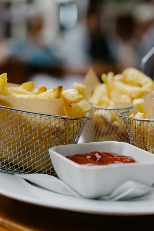 there is a plate of french fries with dipping sauce