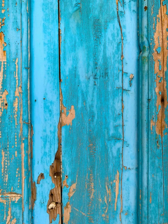 a close - up of blue and peeling wood planks