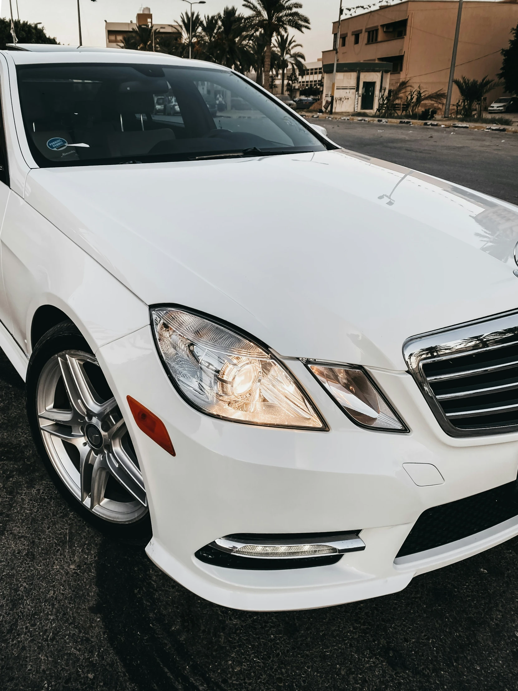 a white car is parked on the street