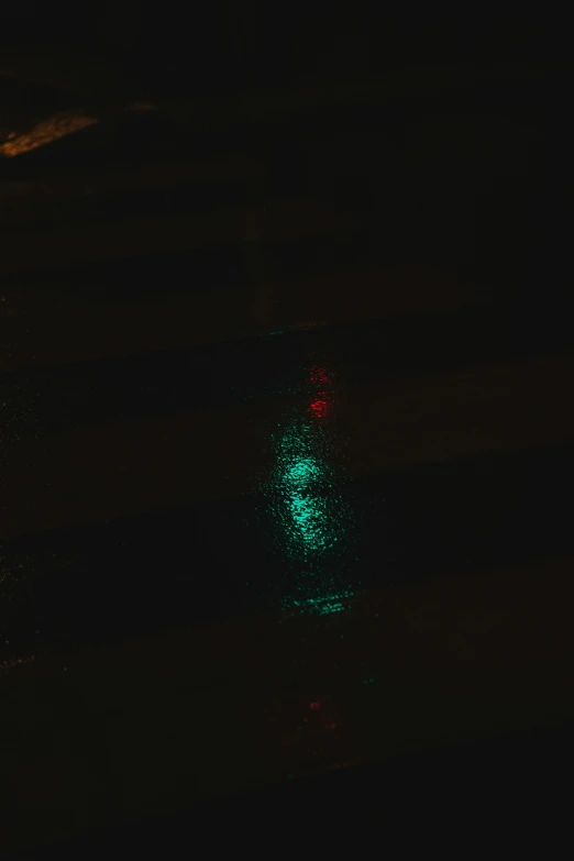 a traffic light glows green in the night