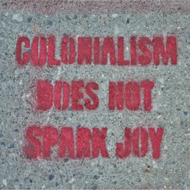 some kind of street sign on concrete writing on the ground