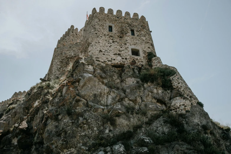 a large stone tower on top of a mountain