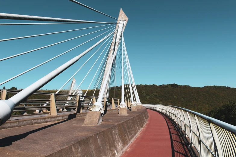 a tall bridge with metal supports against a blue sky