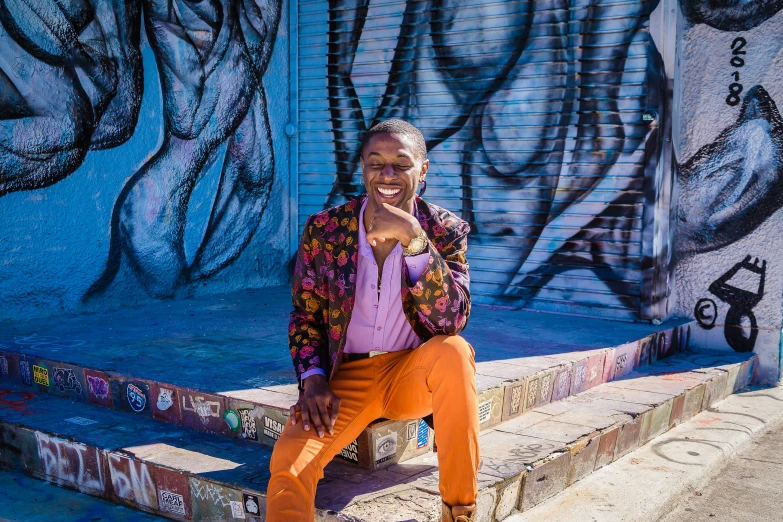 a woman posing in front of a wall with graffiti