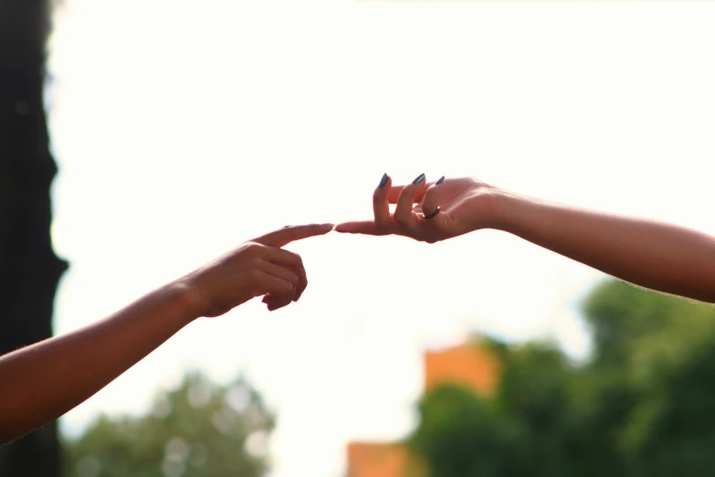 a woman hand pointing to someone while holding her finger