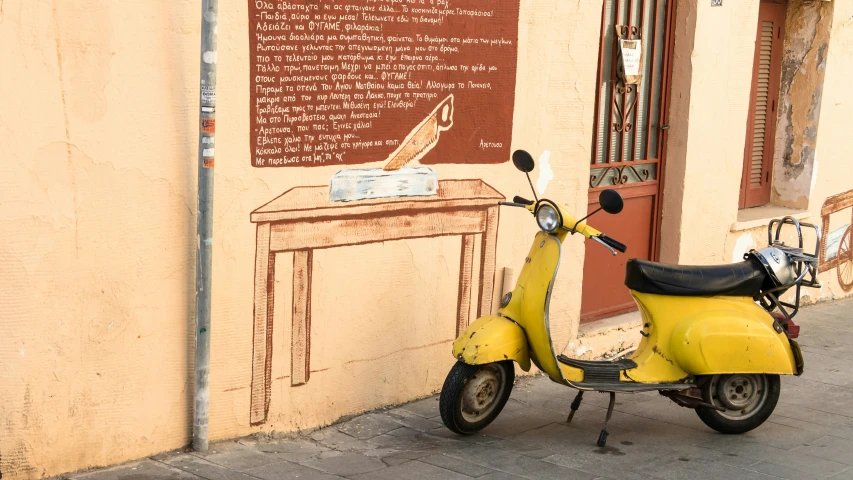 the moped is parked near a small wooden table