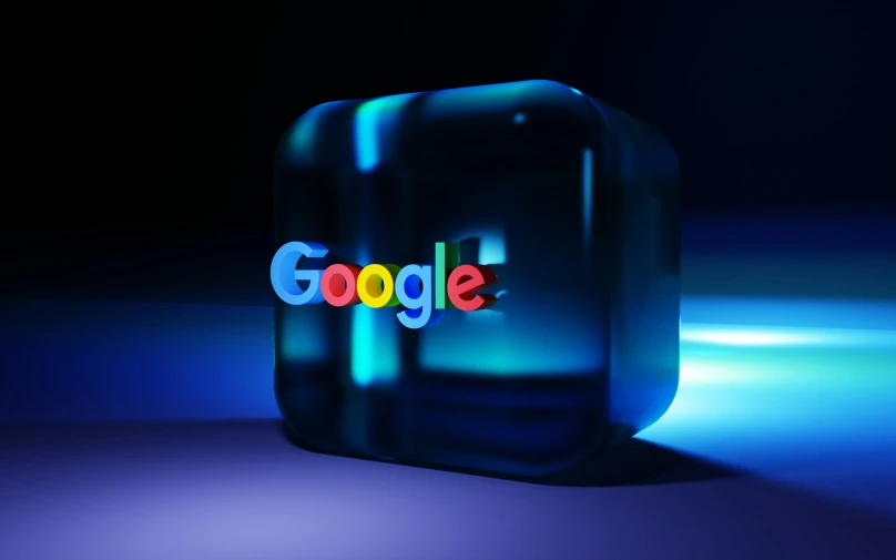 the new logo of google on display in front of a glowing black background