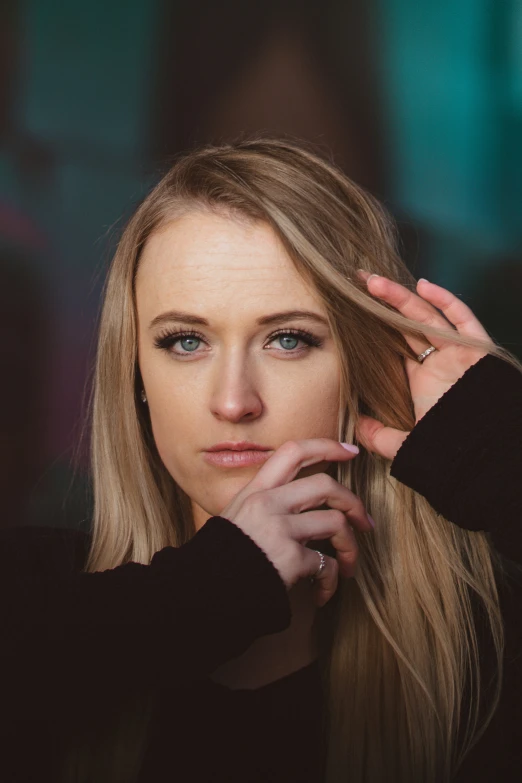 woman with long blond hair sitting at the bar