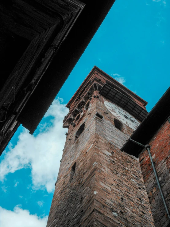 a tall brick building sitting underneath a blue sky