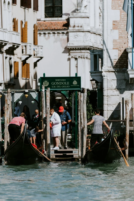 three people ride on gondolas in the water