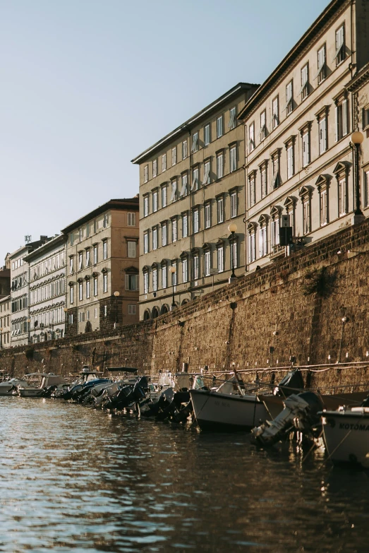 row of boats docked in front of the buildings